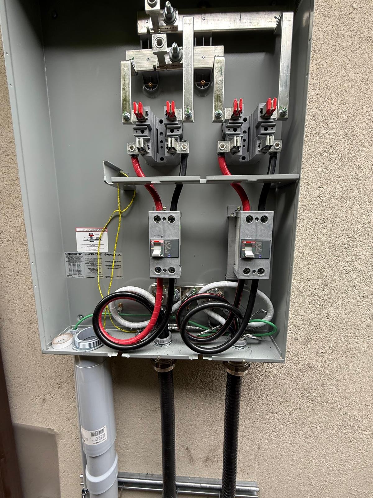 Chief Electrical Ltd. electrician wiring a labelled service panel in a Squamish home